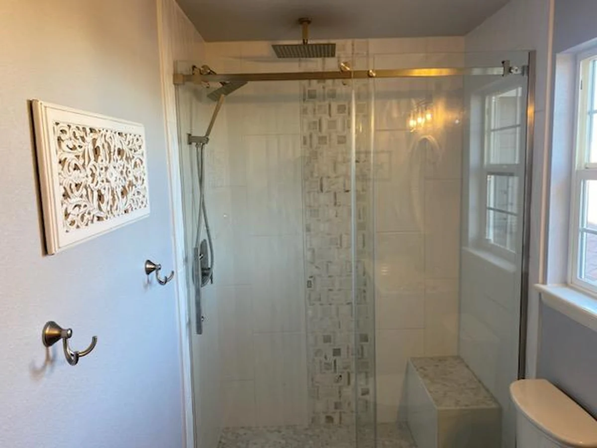 Finished bathroom shower with glass enclosure