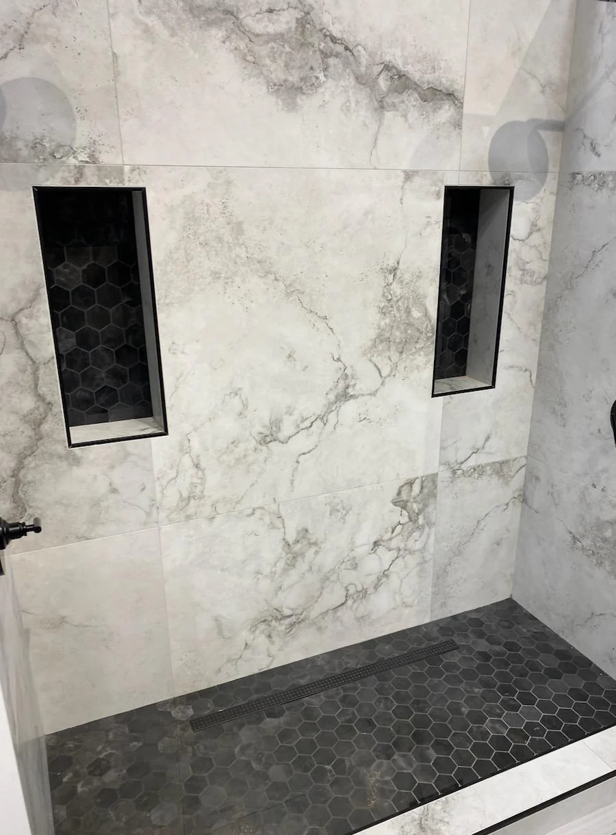 Finished shower tile with black built-in niches