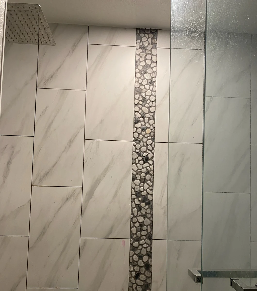 Shower tile accent with pebble detail